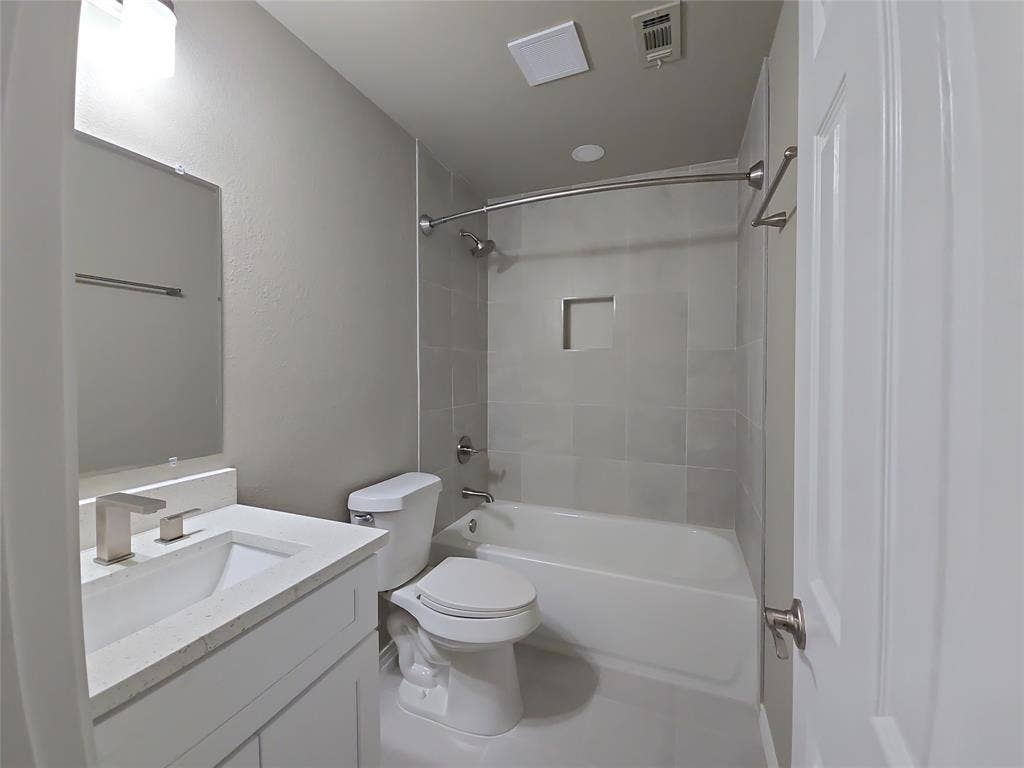 8621 Brunswick Drive, Plano, TX 75024 Open-concept kitchen and dining area featuring wood-finish flooring, white cabinetry, a subway tile backsplash, and stainless steel appliances