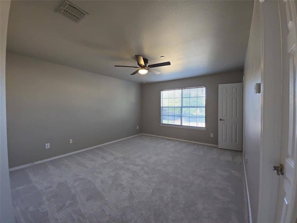 8621 Brunswick Drive, Plano, TX 75024 Expansive room featuring light gray carpeting, neutral-toned walls, and a large window with blinds