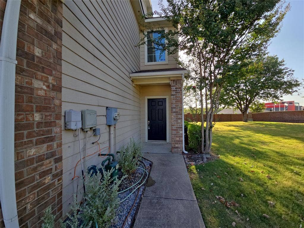 8621 Brunswick Drive, Plano, TX 75024 Siding exterior with brick accents, concrete walkway, and a landscaped bed with gravel and plantings