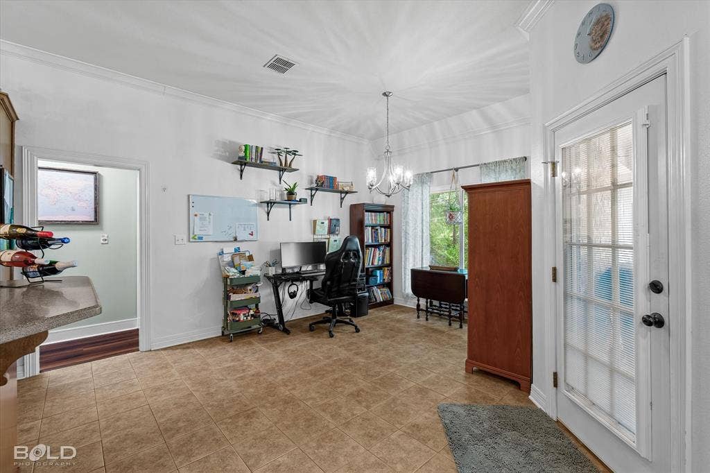 206 Silver Fox Circle, Haughton, LA 71037 Interior room featuring tile flooring, crown molding, a multi-light chandelier, and a glass-paned exterior door