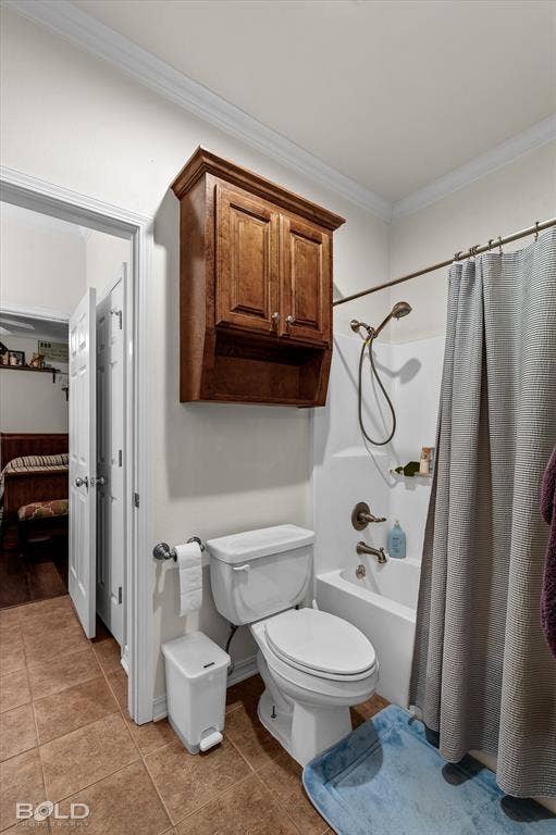 206 Silver Fox Circle, Haughton, LA 71037 Bathroom featuring tile flooring, wall-mounted wood cabinetry, and a bathtub with a handheld shower fixture