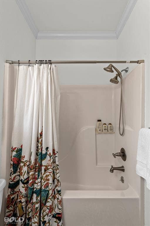 206 Silver Fox Circle, Haughton, LA 71037 Shower and tub combination with a molded surround, integrated soap niche, metallic dual-head shower fixture, and metallic lever faucet