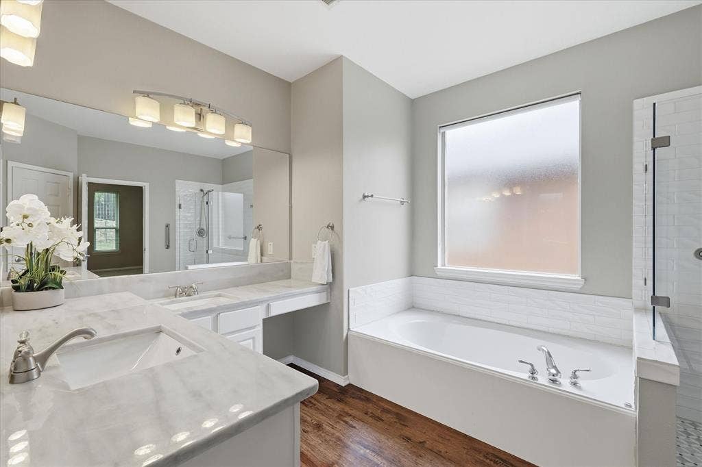 Double vanity with polished countertops, undermount sinks, and chrome faucets