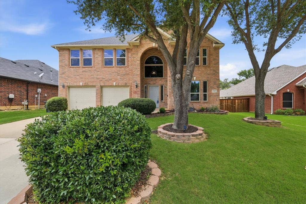 Brick exterior with a gabled roof and arched entry