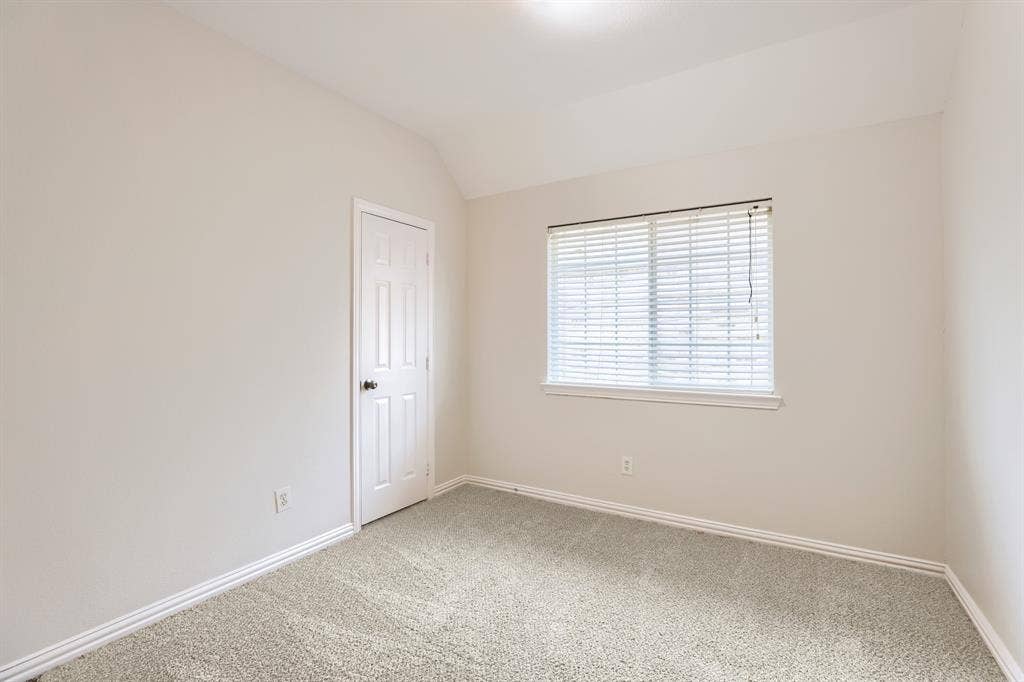 8115 Dogwood Lane, Irving, TX 75063 Light-colored carpet, neutral wall paint, single window with blinds, paneled interior door, and recessed lighting