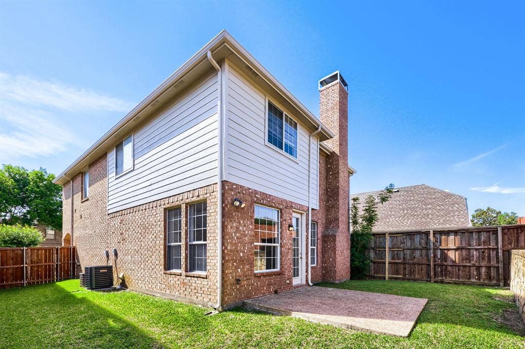 8115 Dogwood Lane, Irving, TX 75063 Brick exterior with white siding accents and a prominent brick chimney