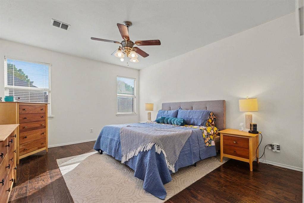 6509 Cartier Court, McKinney, TX 75072 Hardwood-finish flooring, white wall tones, and two windows with blinds