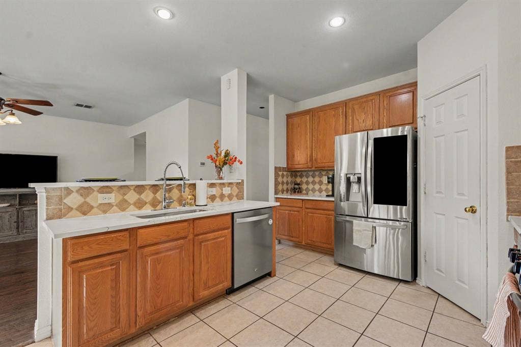 6509 Cartier Court, McKinney, TX 75072 Stainless steel appliances, & new quartz counter tops wood cabinetry.
