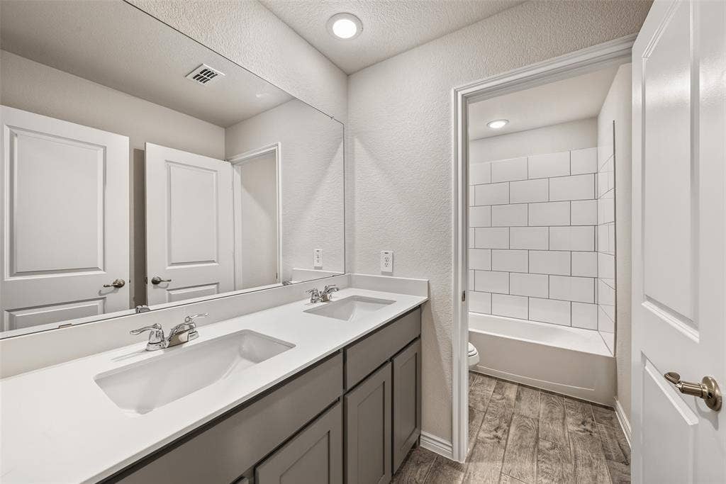 Dual vanity with white undermount sinks and chrome fixtures