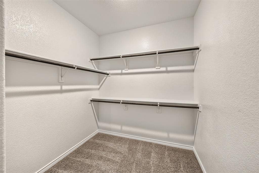 1 of 2  Primary closets with built-in shelving with hanging rods