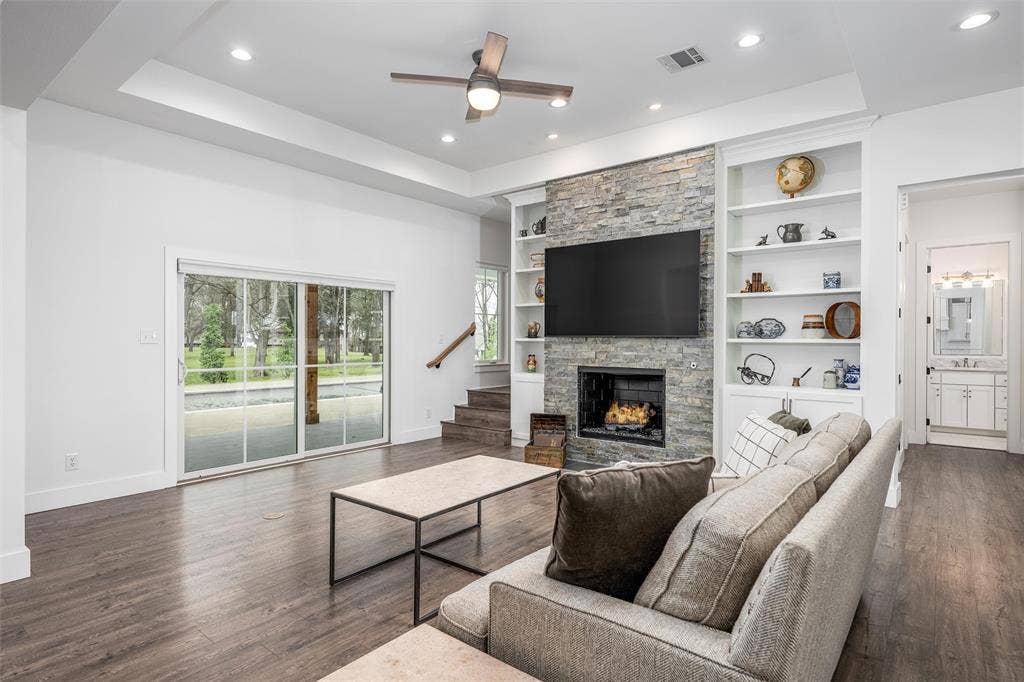 653 Enchanted Isles Drive, Mabank, TX 75156 Inviting living room with fireplace and built in shelving.