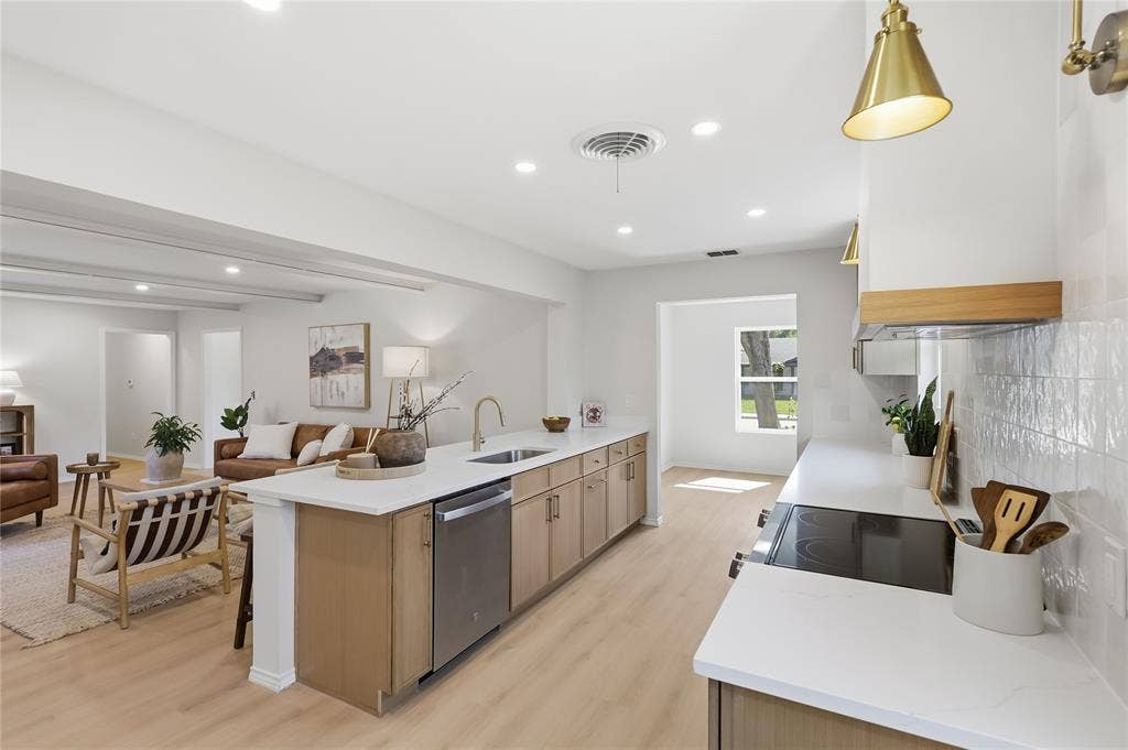 1521 Glenwick Drive, Plano, TX 75075 Kitchen featuring light-finish cabinetry, white countertops, a tiled backsplash, wood-finish flooring, and gold-tone pendant lighting