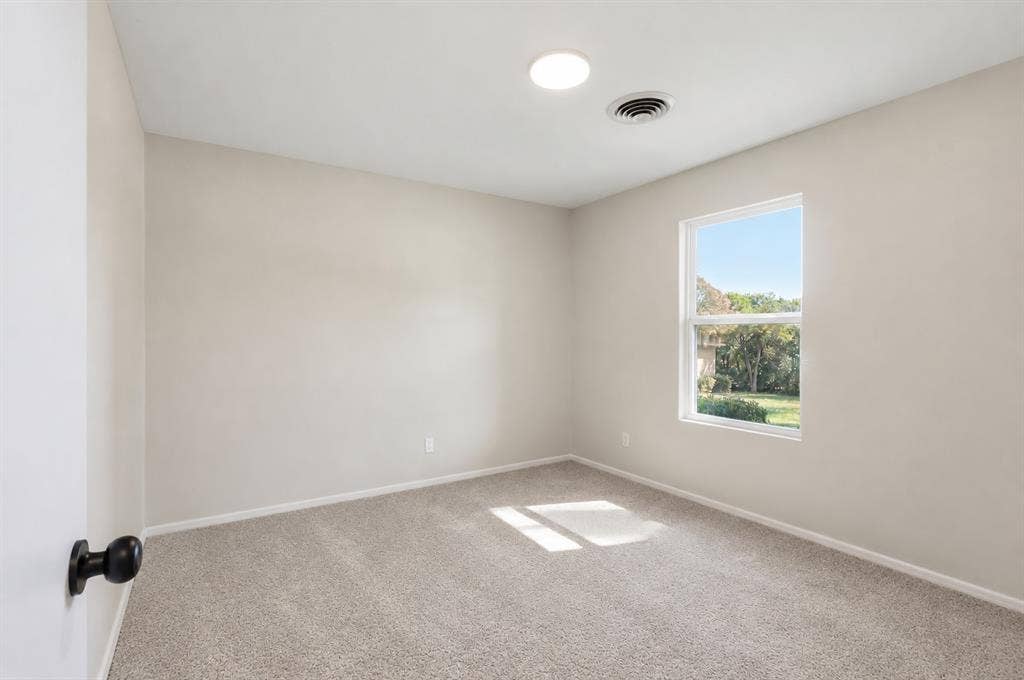 1521 Glenwick Drive, Plano, TX 75075 Neutral interior featuring light-toned wall paint, plush carpeting, a single-hung window, and a flush-mount overhead light fixture