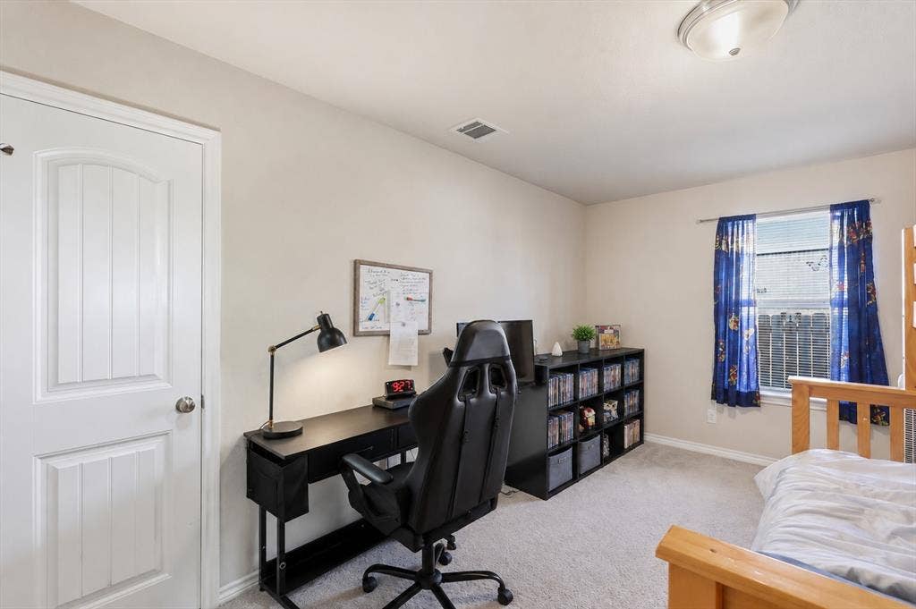 Carpeted room featuring a window with blinds, a white paneled door, and a flush mount ceiling light