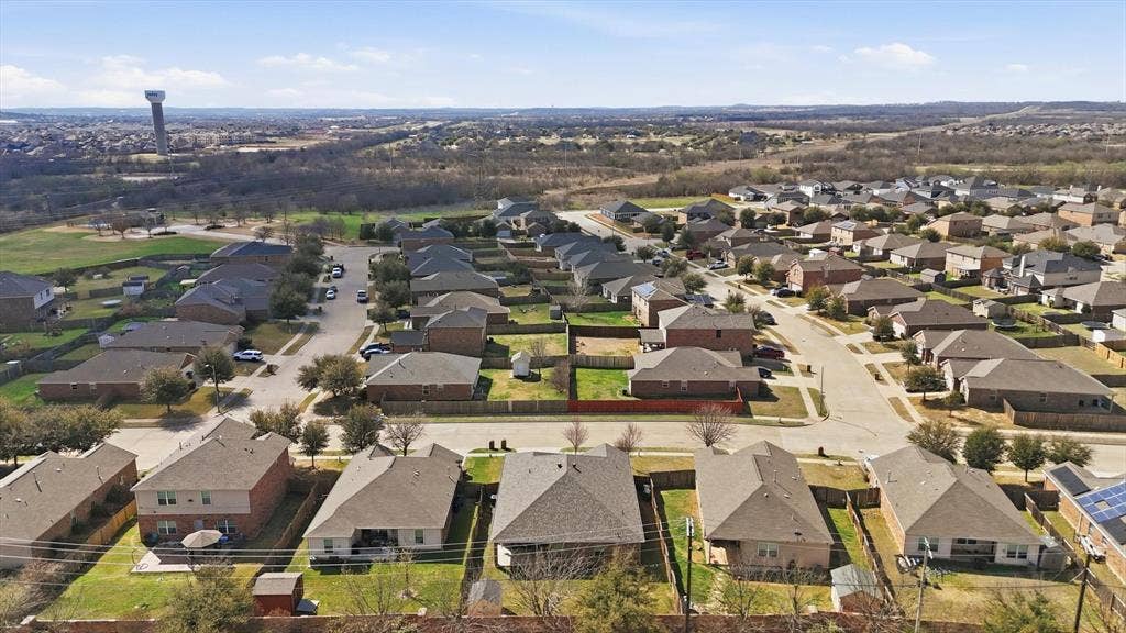 Residential neighborhood featuring single-story and two-story homes with shingle roofs and fenced backyards