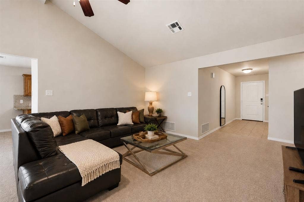 Vaulted ceiling with a ceiling fan, plush carpet flooring, recessed lighting, and a paneled front door