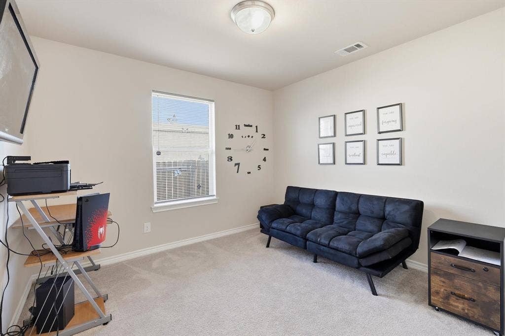 Neutral wall paint, light-toned carpeting, and a window with blinds
