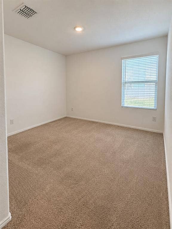 Well-sized secondary bedroom featuring neutral carpeting, recessed lighting, and a  large window for natural light.