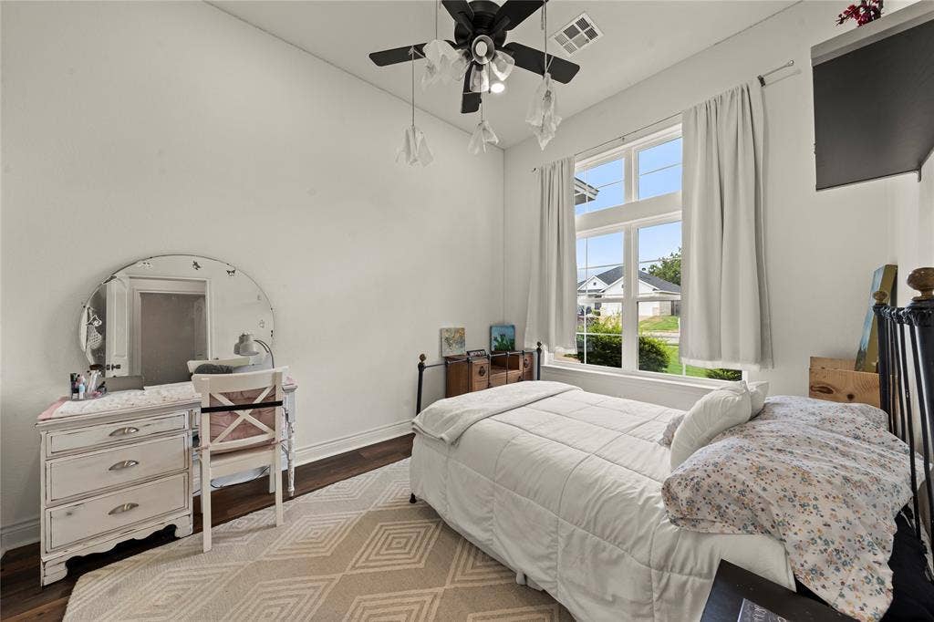 Hardwood-finish flooring, white walls, and a multi-pane window with transom detail