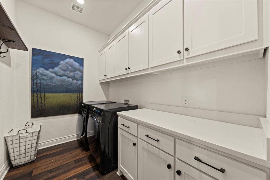 Wood-finish flooring, white shaker cabinetry, white countertop, and a storage shelf with hooks