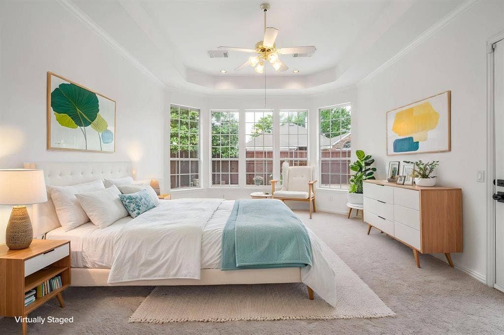 3307 Meadow Wood Drive, Richardson, TX 75082 Tray ceiling with a ceiling fan, bay window with multiple panes, white walls, and a light-toned carpet