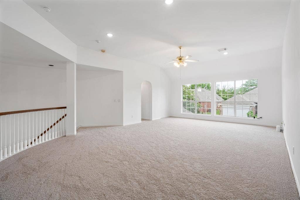 3307 Meadow Wood Drive, Richardson, TX 75082 Vaulted ceiling, recessed lighting, ceiling fan, arched doorway, and carpet flooring