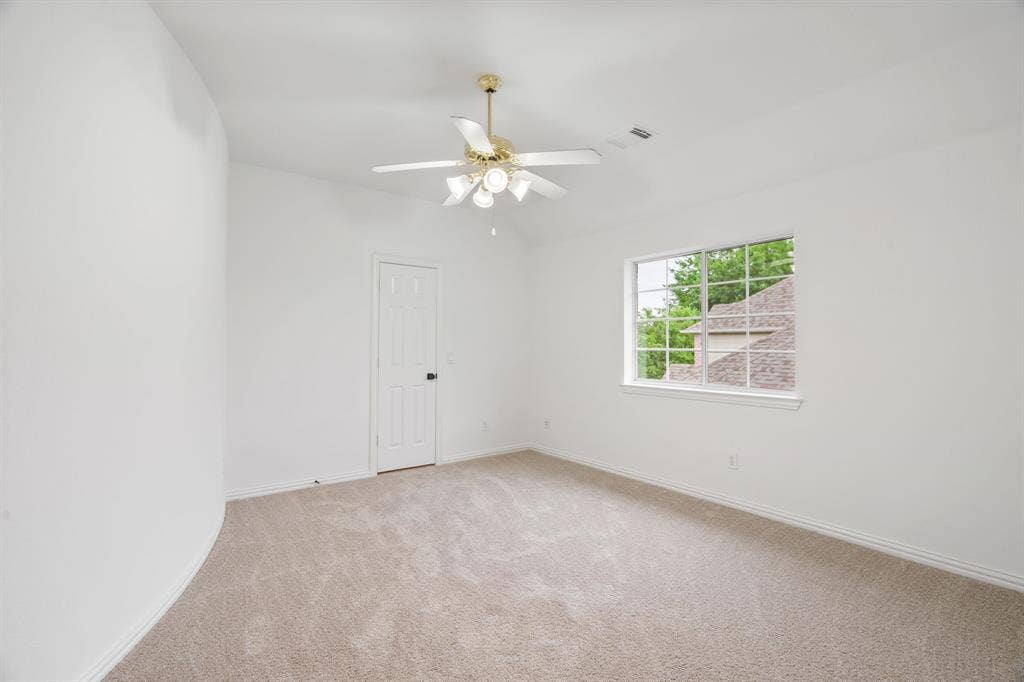 3307 Meadow Wood Drive, Richardson, TX 75082 Carpeted flooring, vaulted ceiling, ceiling fan with light fixture, white interior door, and a multi-pane window