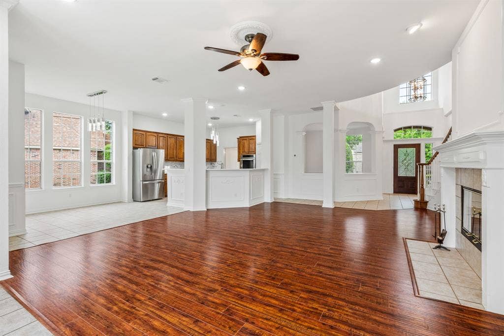 3307 Meadow Wood Drive, Richardson, TX 75082 Spacious interior with wood-finish flooring, a ceiling fan, and a tiled fireplace