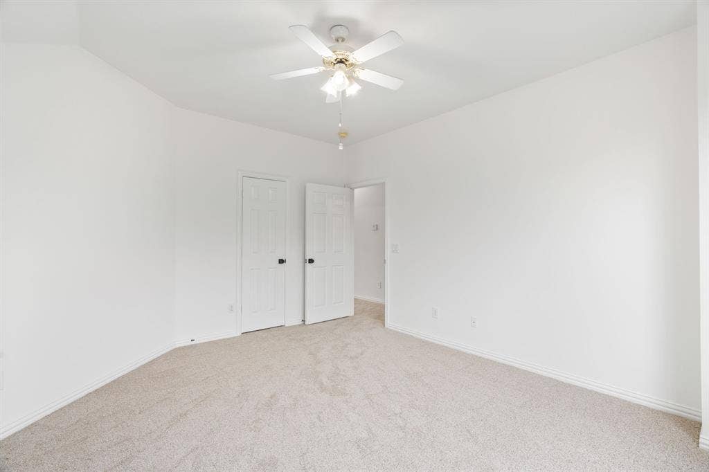 3307 Meadow Wood Drive, Richardson, TX 75082 Neutral-toned carpeting with white walls and a ceiling fan with integrated lighting