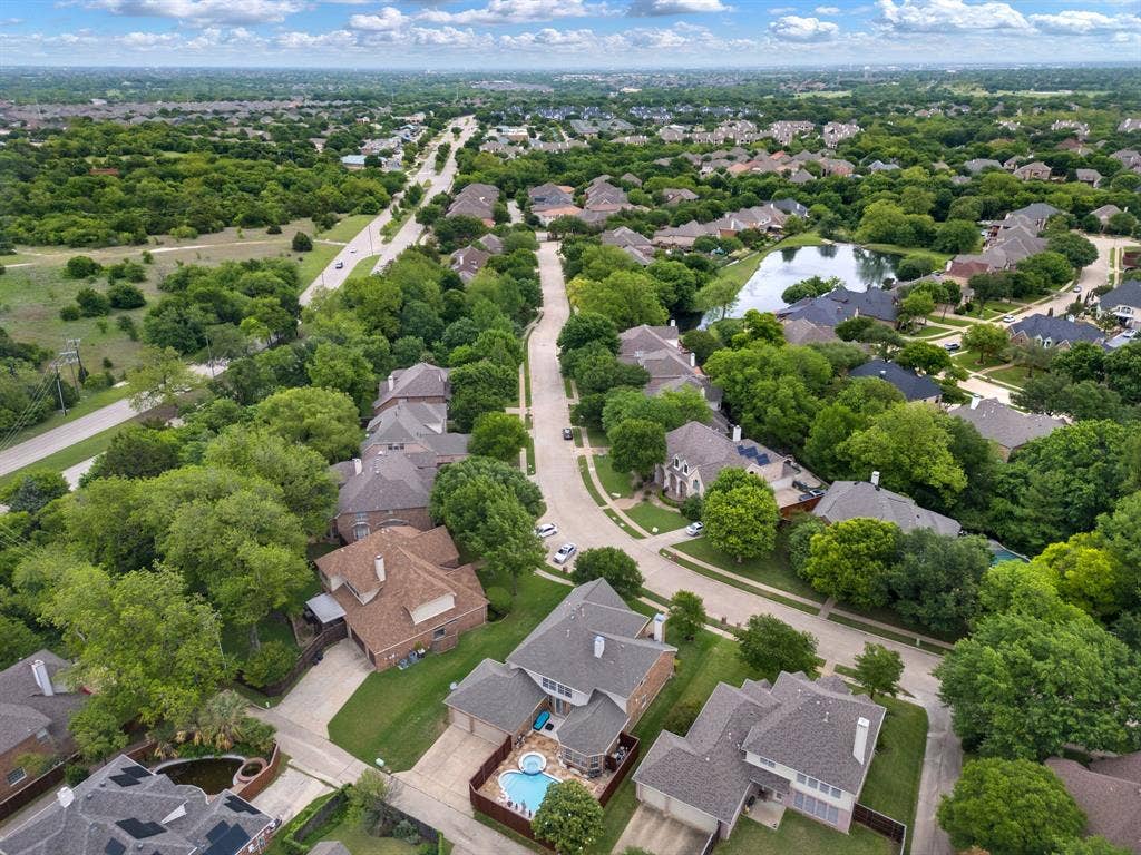 3307 Meadow Wood Drive, Richardson, TX 75082 Residential area featuring mature trees, a street network, and a pond