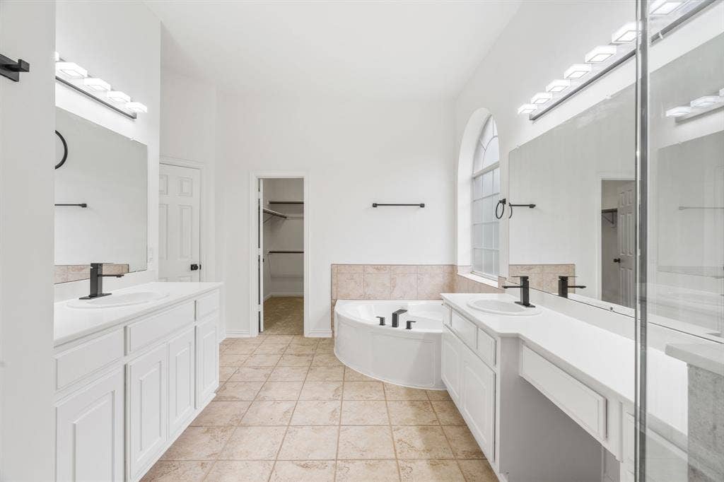 3307 Meadow Wood Drive, Richardson, TX 75082 Dual vanities with white cabinetry and integrated sinks