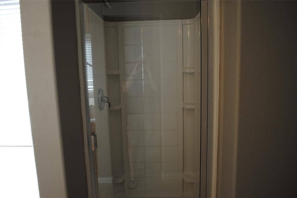 5108 Blackwood Drive, McKinney, TX 75071 Shower enclosure with clear glass door and wall-mounted fixtures