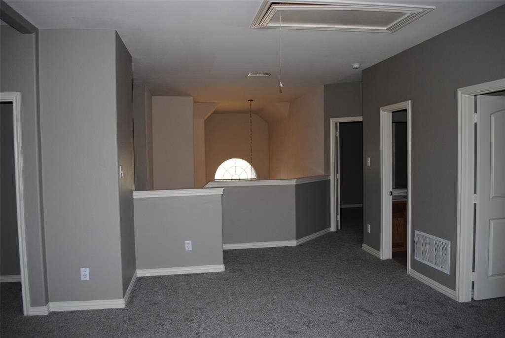 5108 Blackwood Drive, McKinney, TX 75071 Carpeted flooring, vaulted ceiling, arched window, and multiple interior doorways
