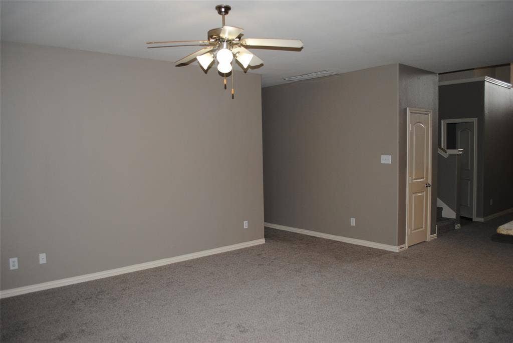 5108 Blackwood Drive, McKinney, TX 75071 Neutral-toned carpeting, light gray wall paint, and a ceiling fan with integrated lighting