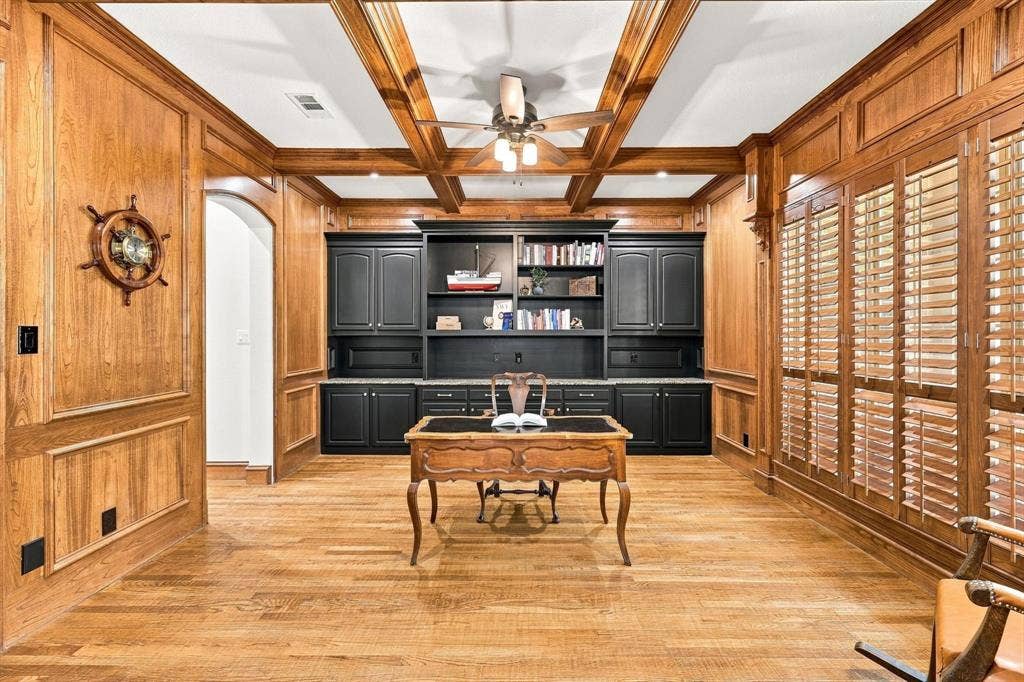 Hardwood flooring with wood-paneled walls and wainscoting