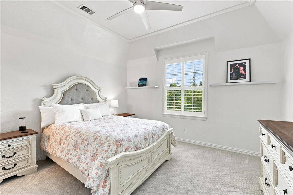 High ceilings, a ceiling fan, and carpeted flooring