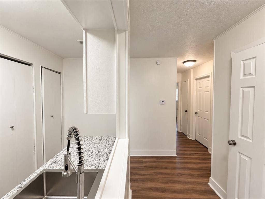 2002 Washington Street, #3, Commerce, TX 75428 Kitchen pass-through with a stainless steel undermount sink and a coiled spring faucet