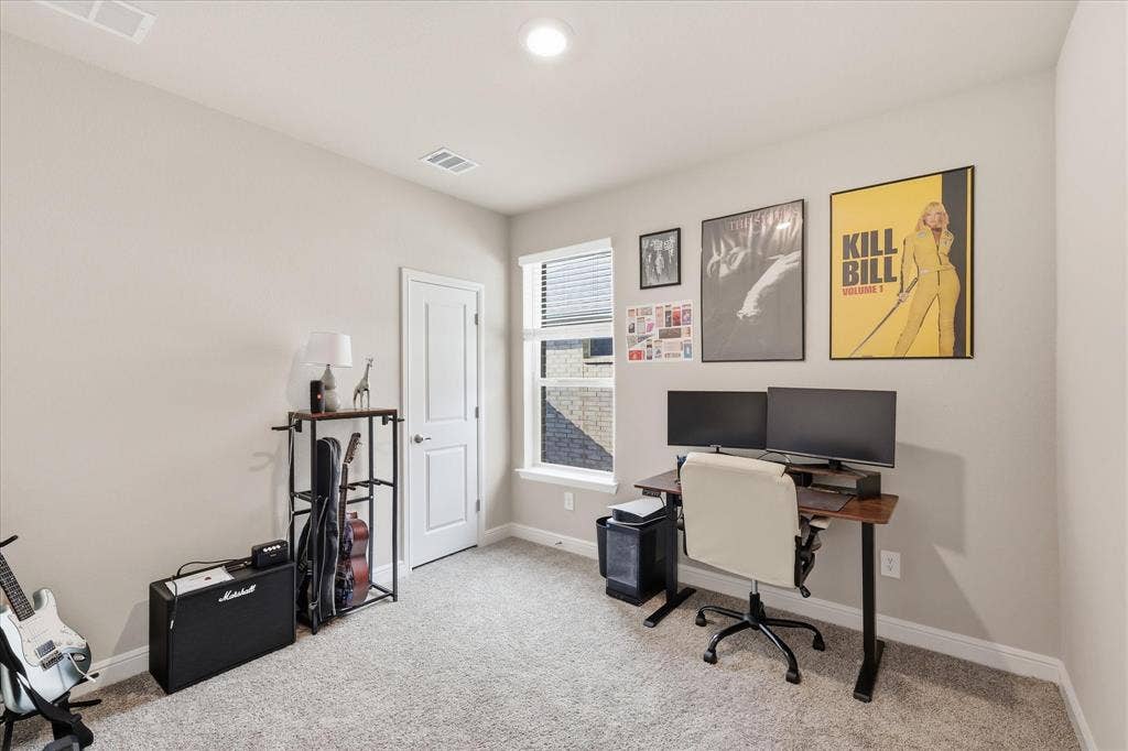 Neutral-toned walls complement the textured carpet flooring