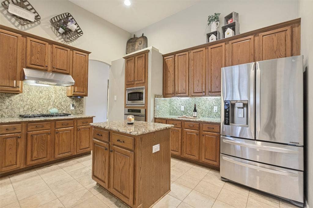 5406 Xavier Place, Richardson, TX 75082 Kitchen with a gas cooktop, plenty of counter space and an island with cabinets