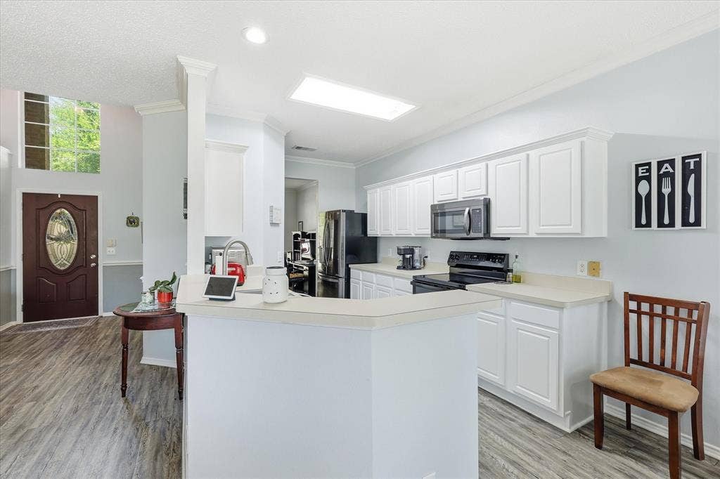 2112 Loon Lake Road, Denton, TX 76210 Kitchen featuring white cabinetry, light countertops, and black appliances