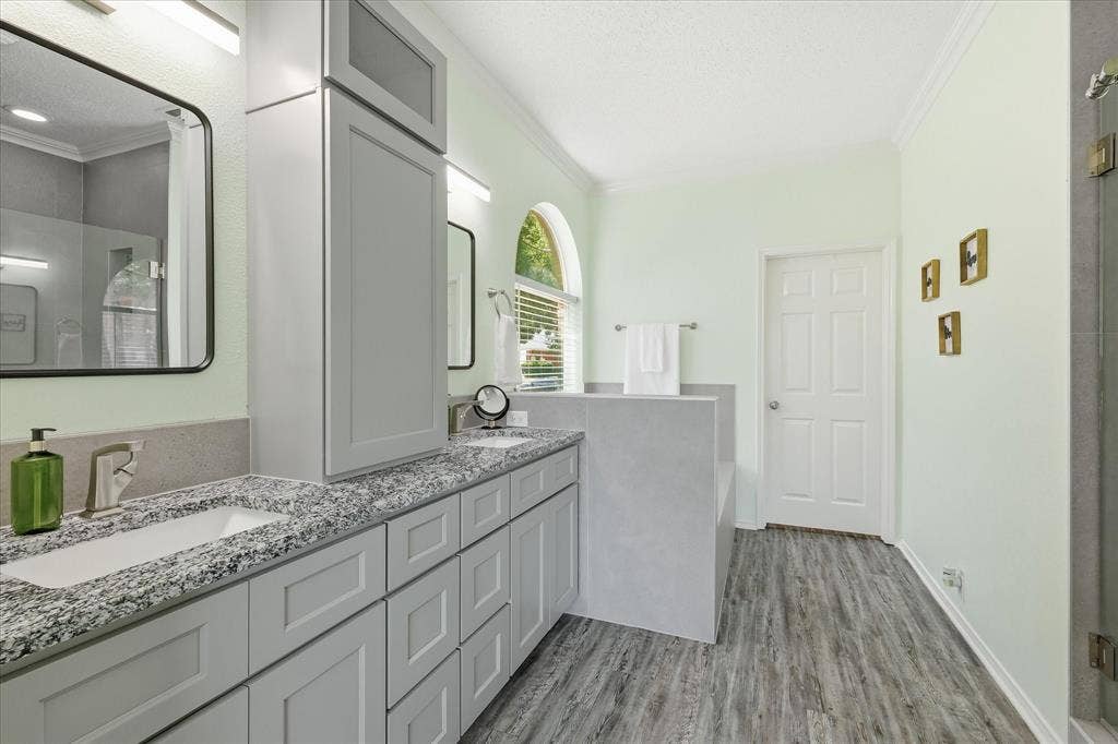 2112 Loon Lake Road, Denton, TX 76210 Dual vanity with granite countertops, light gray cabinetry, wood-finish flooring, and arched window