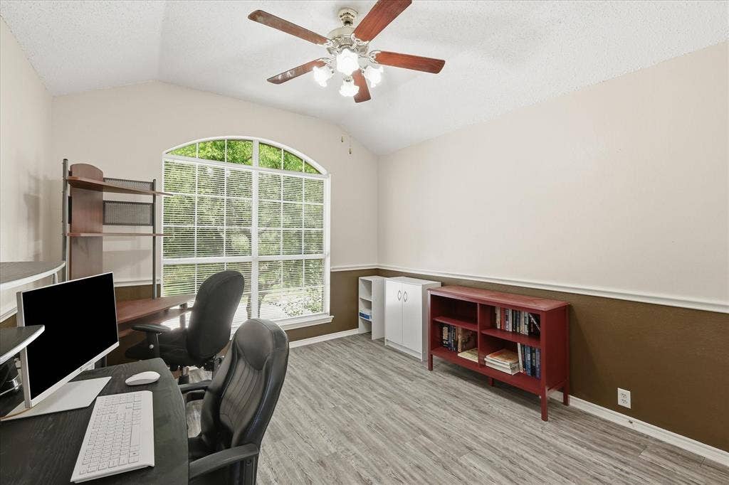 2112 Loon Lake Road, Denton, TX 76210 Vaulted ceiling with a ceiling fan, arched window, wood-finish flooring, and chair rail molding