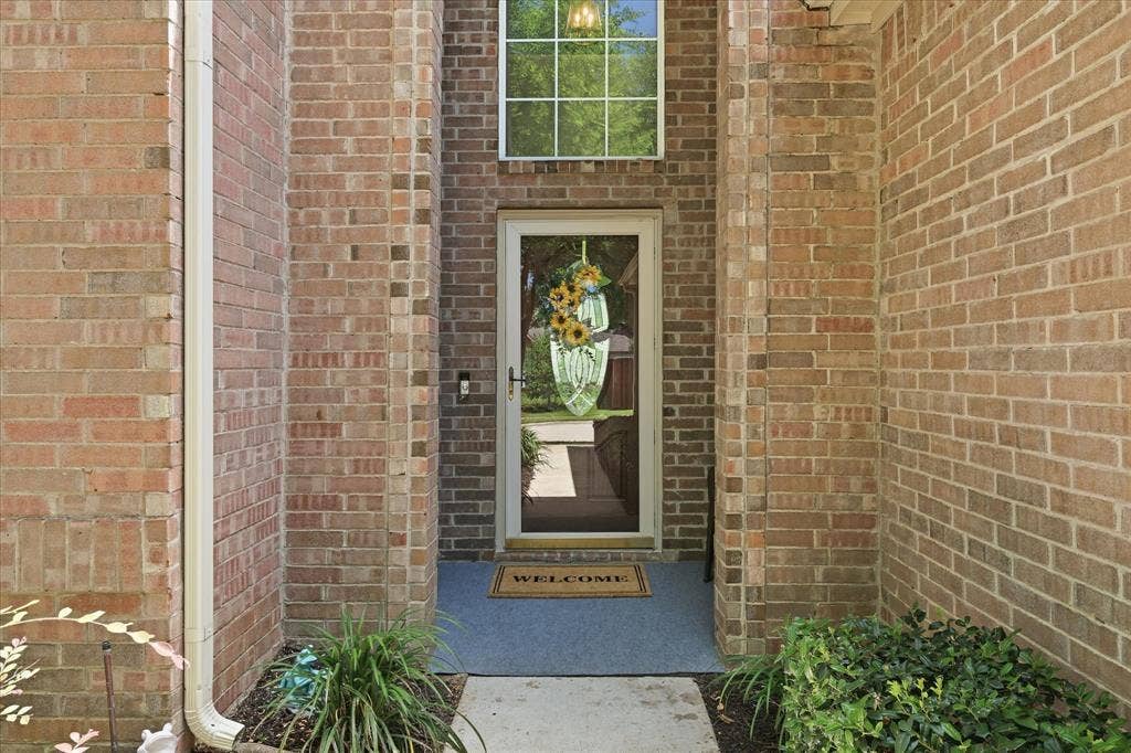 2112 Loon Lake Road, Denton, TX 76210 Brick exterior with a transom window and a glass-paneled front door