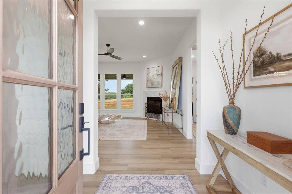 124 Norene Lane, Weatherford, TX 76088 Recessed lighting, wood-finish flooring, and a fireplace with a stone surround