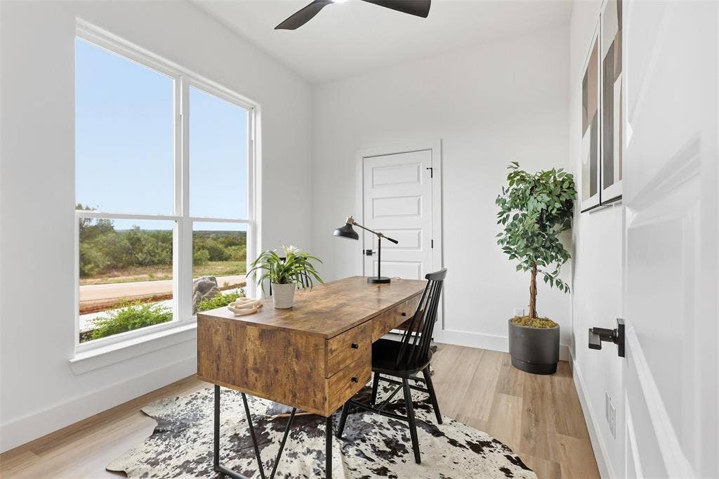 124 Norene Lane, Weatherford, TX 76088 Hardwood-style flooring, white paneled doors, and a ceiling fan with integrated lighting