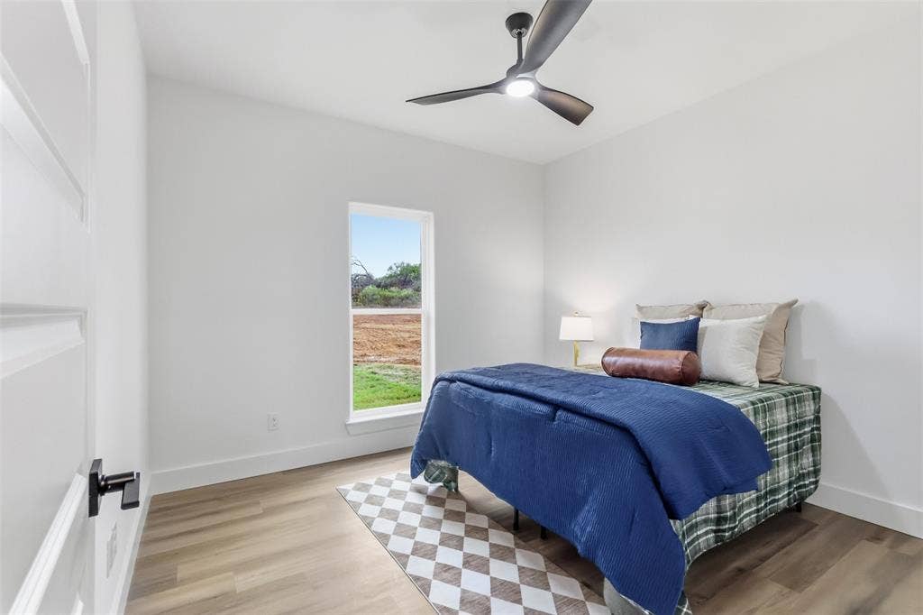 124 Norene Lane, Weatherford, TX 76088 Wood-finish flooring, white walls, and a contemporary ceiling fan with integrated lighting