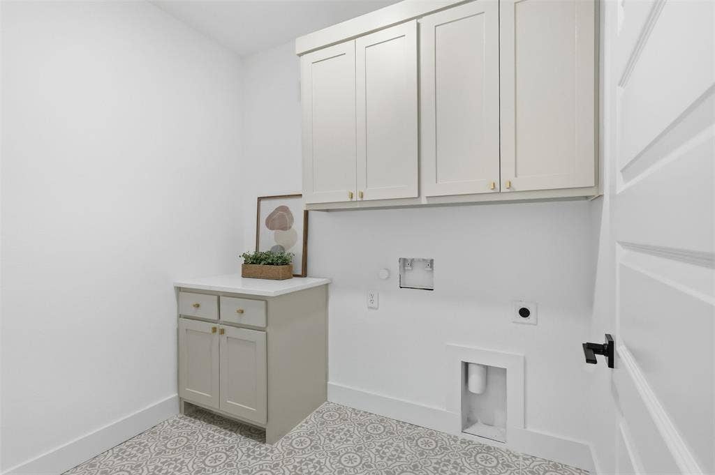 124 Norene Lane, Weatherford, TX 76088 Built-in cabinetry with gold-toned hardware, white countertop, and patterned floor tile