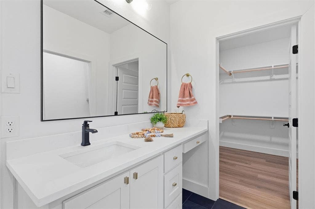 124 Norene Lane, Weatherford, TX 76088 Built-in vanity with white cabinetry, matte black faucet, and rectangular undermount sink