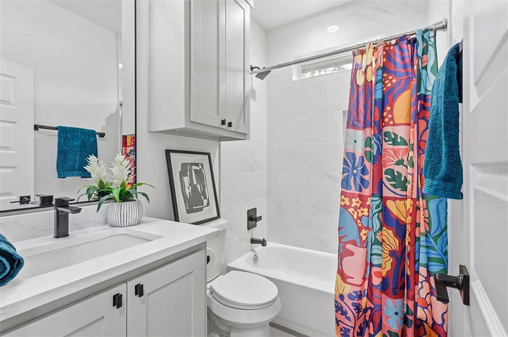 124 Norene Lane, Weatherford, TX 76088 Vanity with an integrated sink, matte black faucet, and white countertop