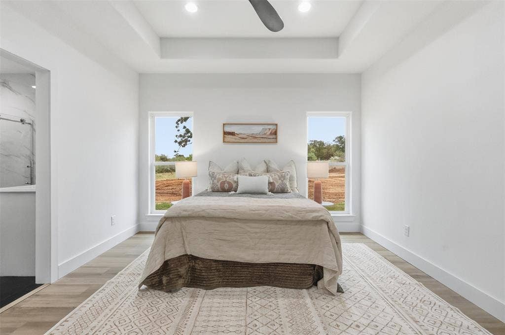 124 Norene Lane, Weatherford, TX 76088 Recessed lighting, ceiling fan, tray ceiling, wood-finish flooring, and a full window